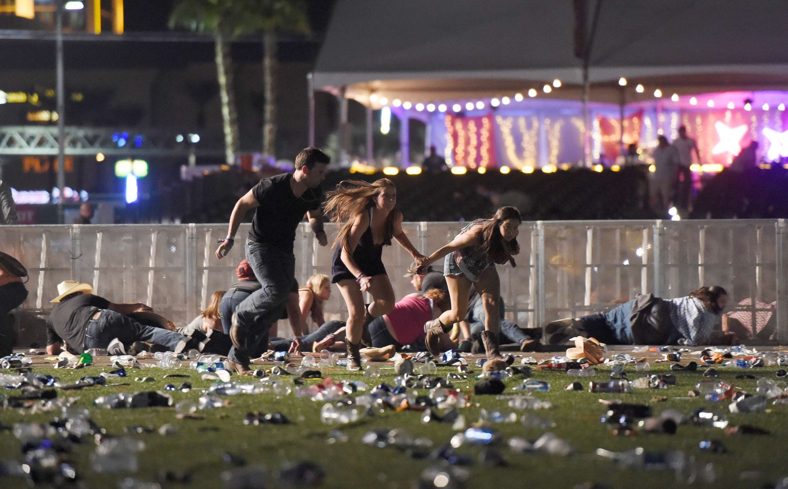 PHOTO: People run from the Route 91 Harvest country music festival, Oct. 1, 2017, in Las Vegas.