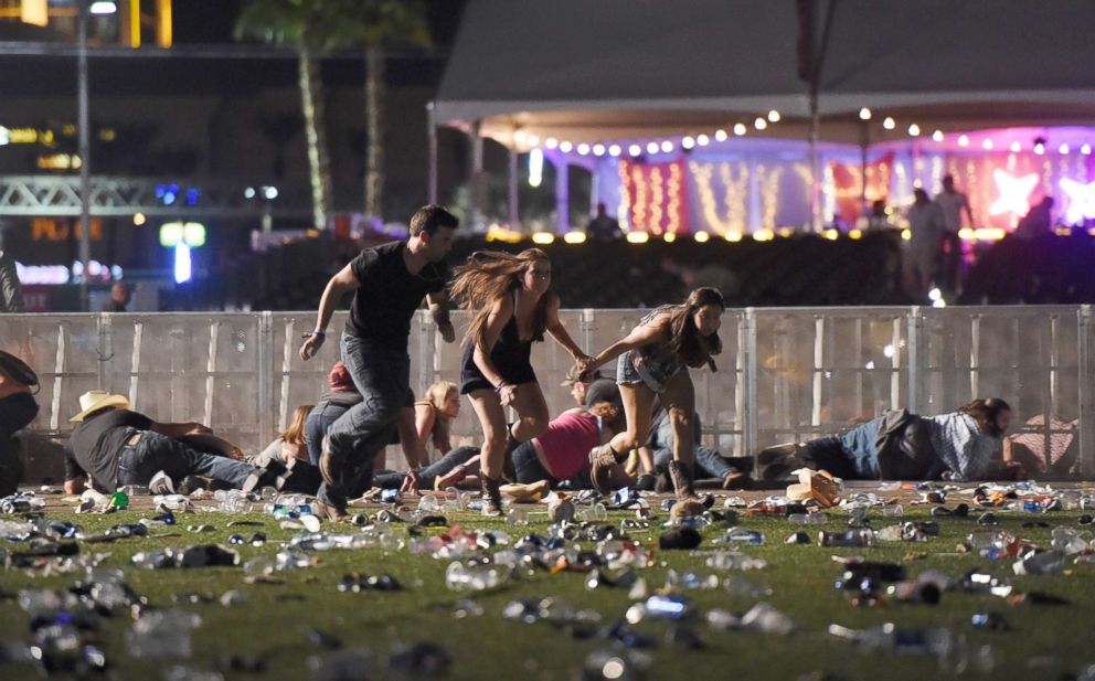 PHOTO: People run from the Route 91 Harvest country music festival, Oct. 1, 2017, in Las Vegas.