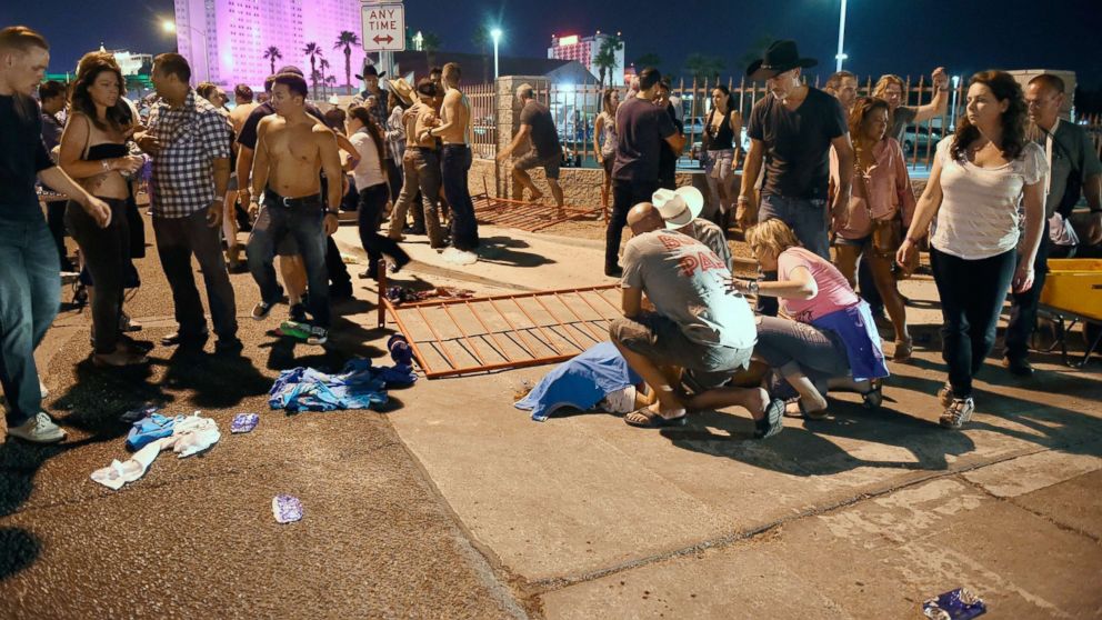PHOTO: People tend to the wounded outside the festival grounds, Oct. 1, 2017, in Las Vegas.