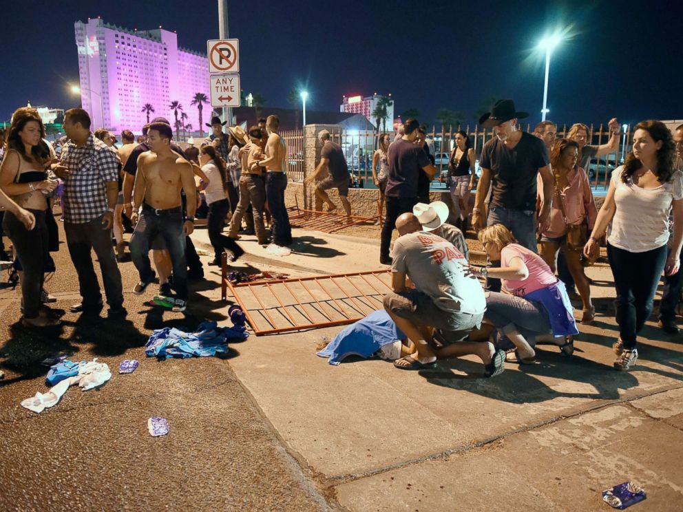 PHOTO: People tend to the wounded outside the festival grounds, Oct. 1, 2017, in Las Vegas.