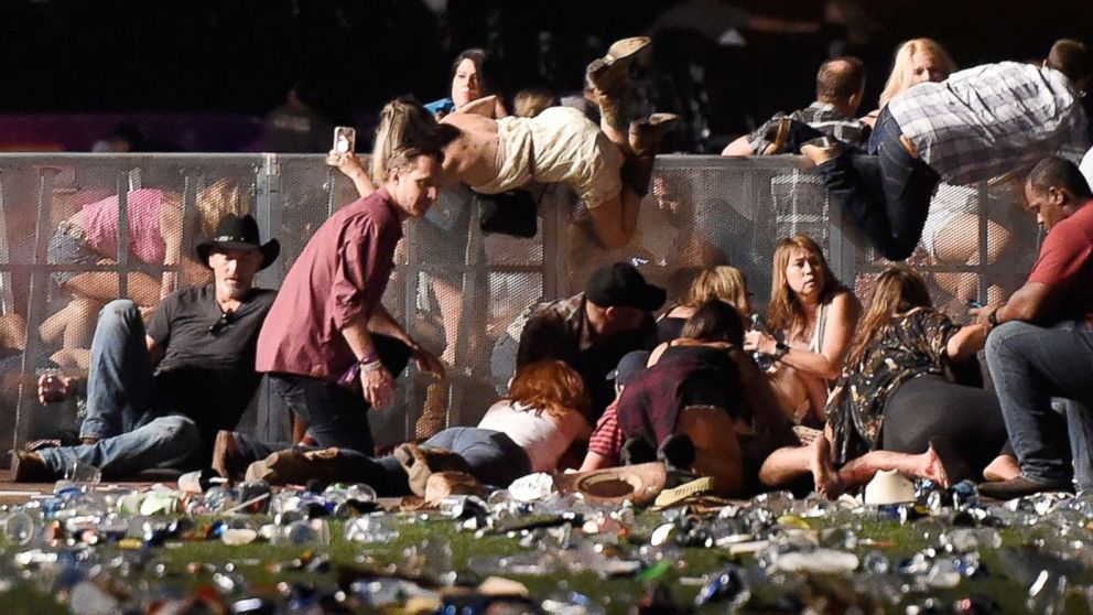 PHOTO: People scramble for shelter at the Route 91 Harvest country music festival, Oct. 1, 2017, in Las Vegas.