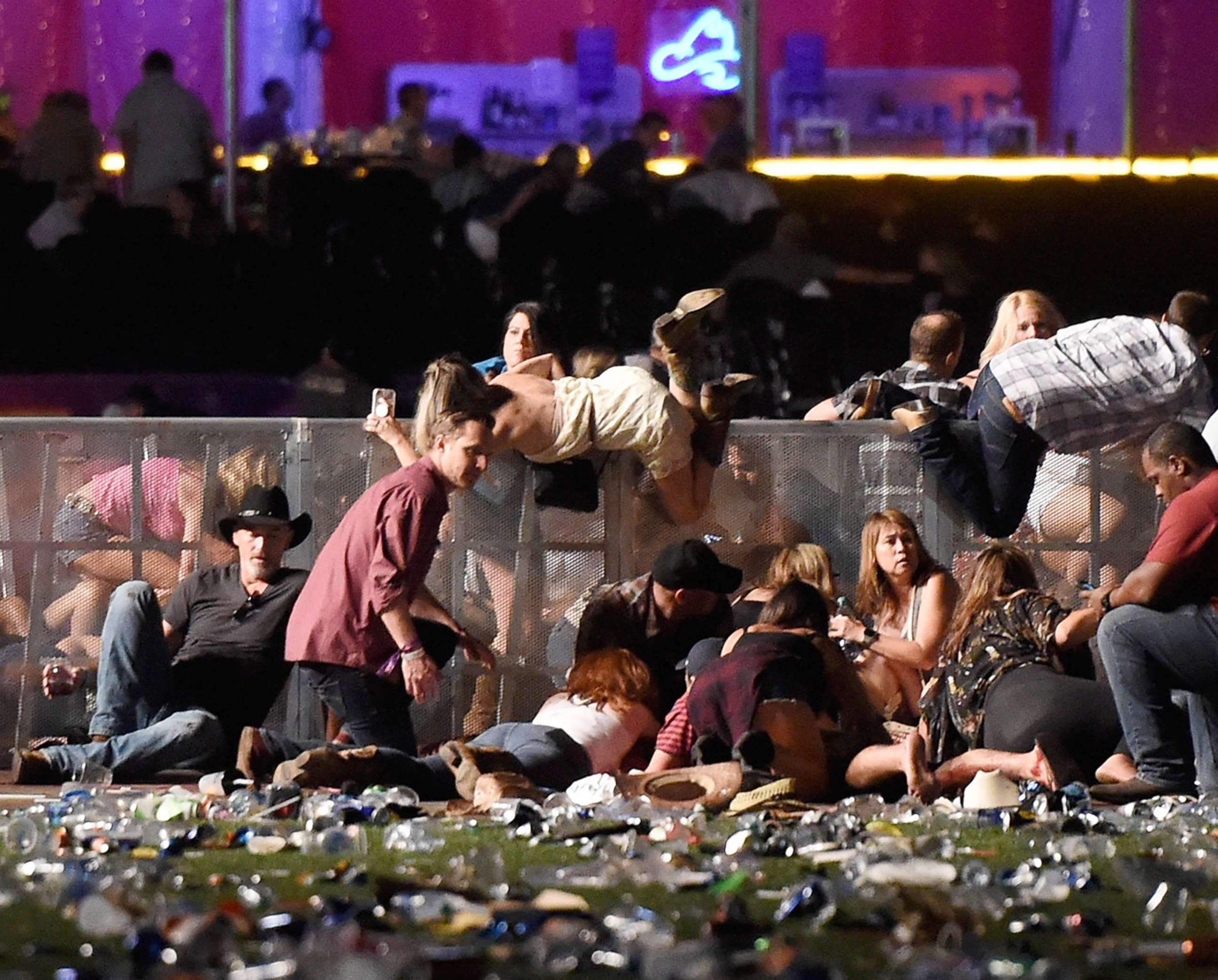 PHOTO: People scramble for shelter at the Route 91 Harvest country music festival, Oct. 1, 2017, in Las Vegas.