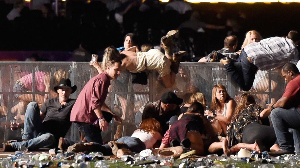 PHOTO: People scramble for shelter at the Route 91 Harvest country music festival, Oct. 1, 2017, in Las Vegas.