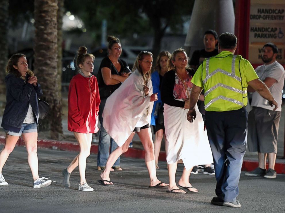 PHOTO: People are directed to rides outside the Thomas & Mack Center after a mass shooting at a country music festival, Oct. 2, 2017, in Las Vegas.