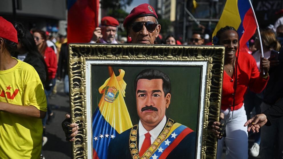 PHOTO: A man holds a picture of ousted Venezuelan President Nicolas Maduro during a rally in support of Maduro and his wife, Cilia Flores, in Caracas, January 6, 2026. 