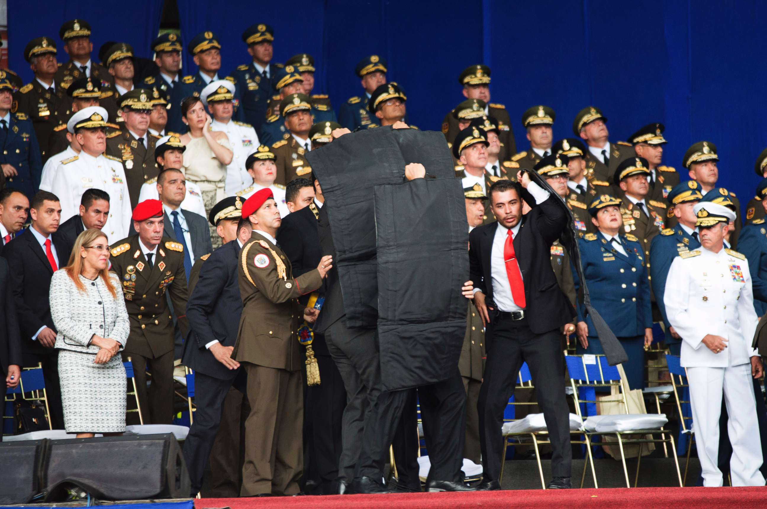 PHOTO: In this photo released by China's Xinhua News Agency, security personnel surround Venezuela's President Nicolas Maduro during an incident as he was giving a speech in Caracas, Venezuela, Aug. 4, 2018.