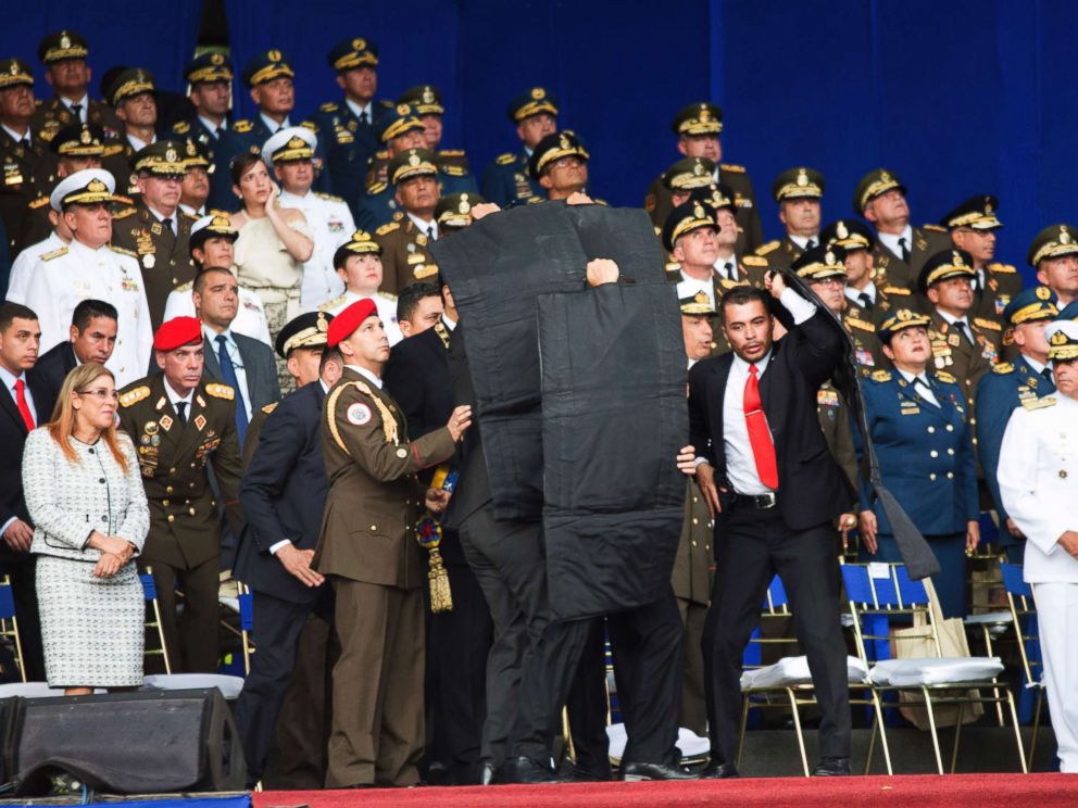 PHOTO: In this photo released by Chinas Xinhua News Agency, security personnel surround Venezuelas President Nicolas Maduro during an incident as he was giving a speech in Caracas, Venezuela, Aug. 4, 2018.