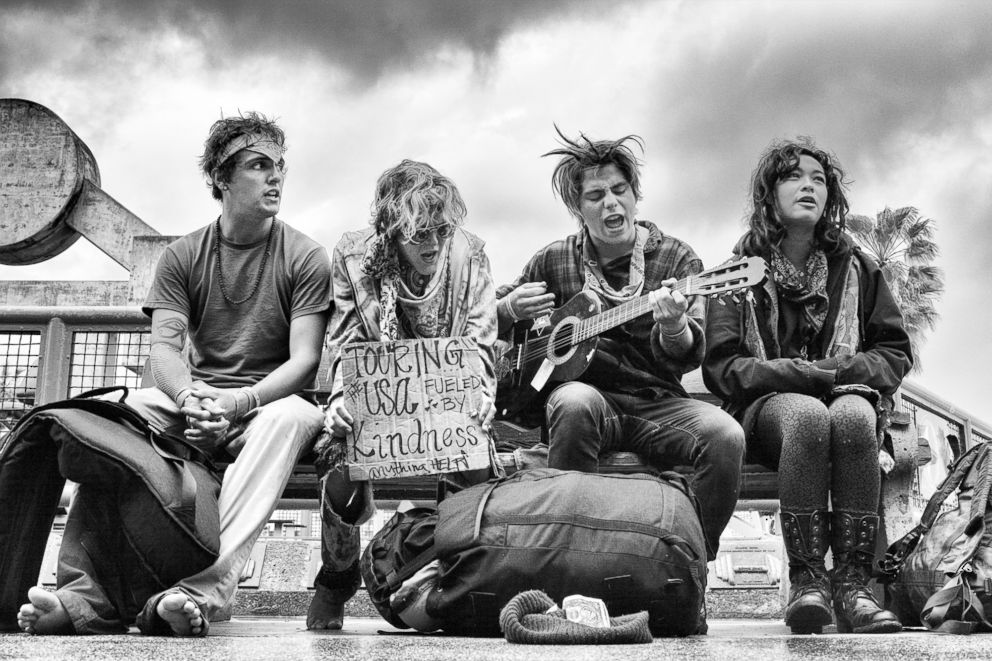 PHOTO: Singing in the Rain - A group of young hippies sing on a bench across from the Muscle Beach Gym.