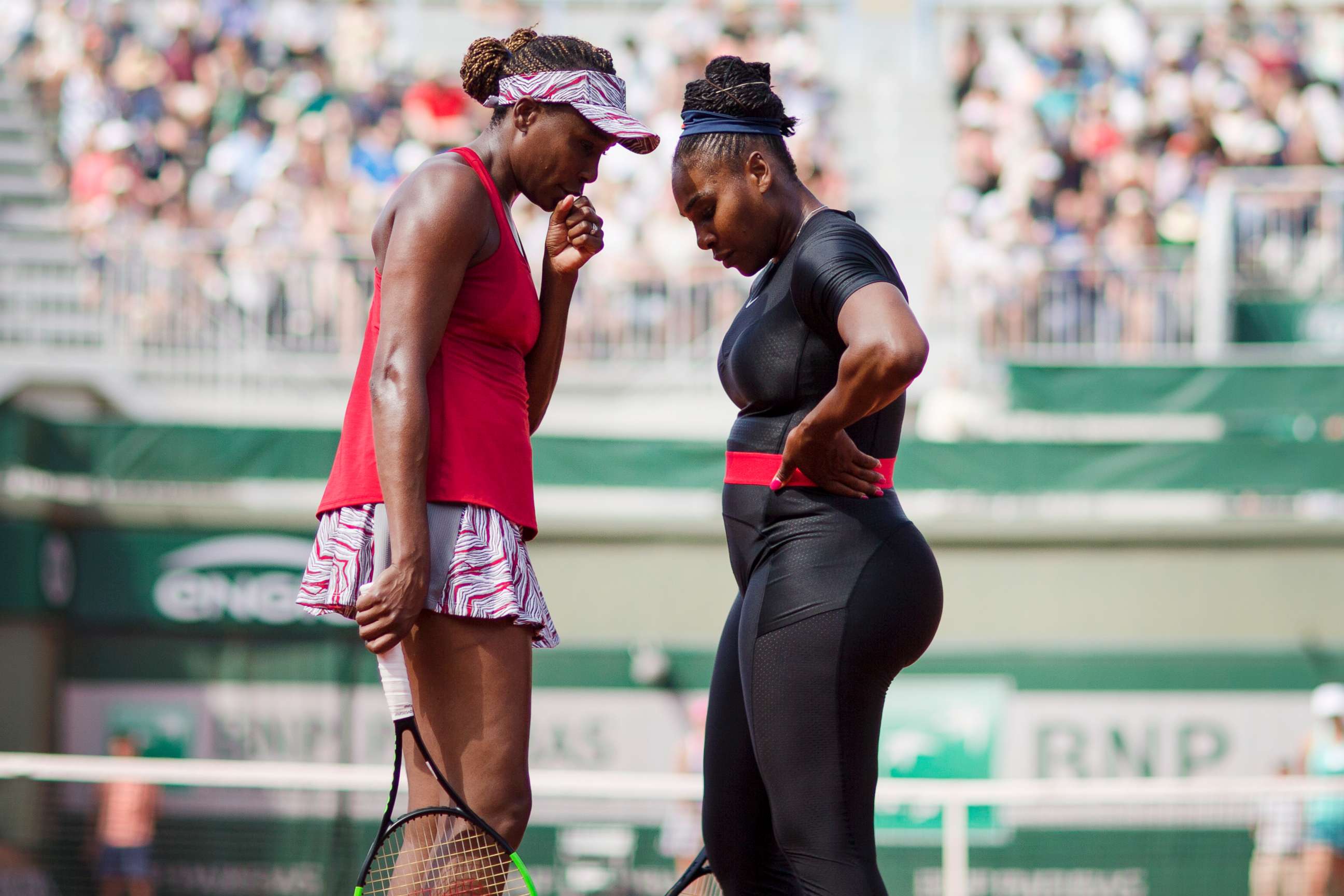 PHOTO: Serena Williams and Venus Williams talk during their match against Andreja Klepac of Slovenia and Maria Jose Martinez Sanchez of Spain in the Women's Doubles Competition at the 2018 French Open Tennis Tournament in Paris, June 3, 2018.