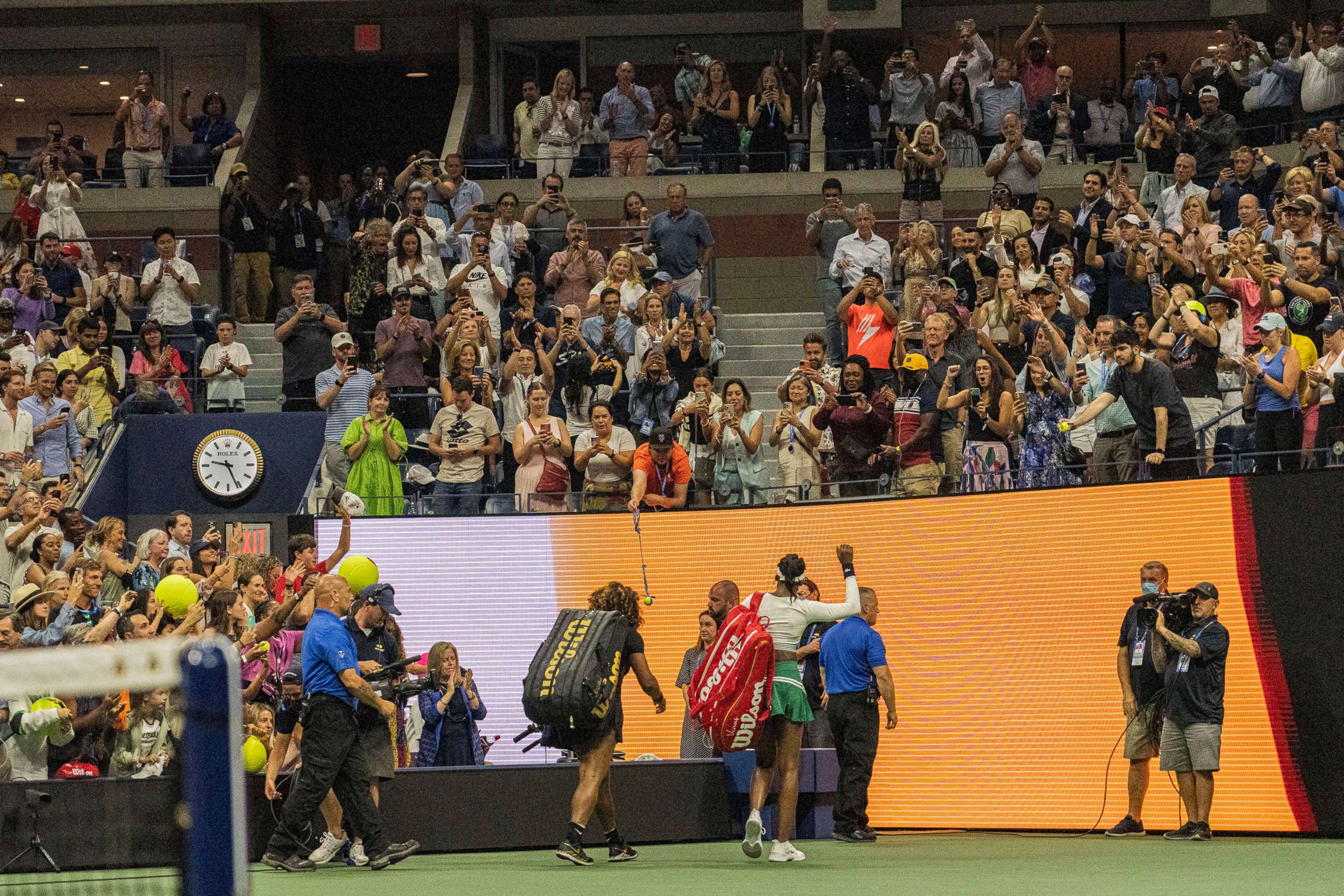 PHOTO: Serena and Venus Williams leave the court after playing in the first round of Women's Doubles on the fourth day of the US Open in Queens, New York. Sept. 1, 2022.