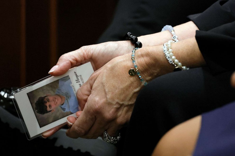 PHOTO: Gena Hoyer holds a photograph of her son, Luke, who was killed in the 2018 shootings, as she awaits the verdict in the trial of MSD High School shooter Nikolas Cruz at the Broward County Courthouse Oct. 13, 2022 in Fort Lauderdale, Fla.