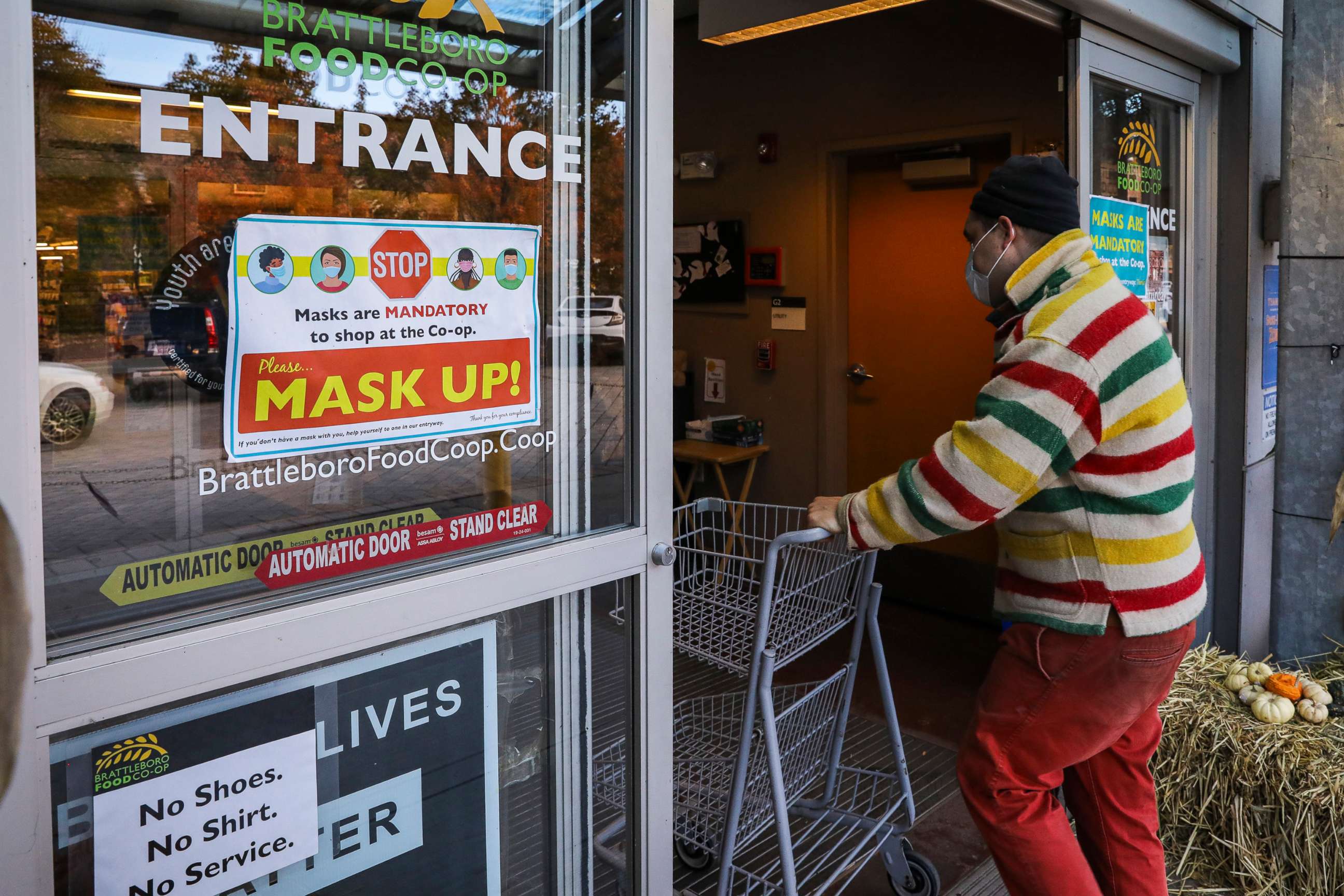 PHOTO: A mask up! sign greets customers at the entrance of the Brattleboro Food Co-op, Oct. 29, 2021, in downtown Brattleboro, Vt. 