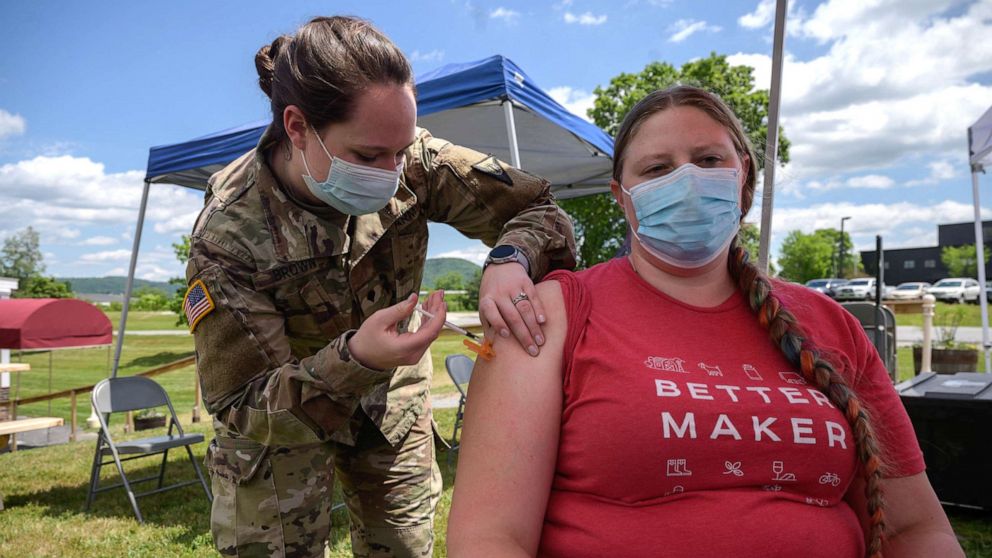 PHOTO: An employee receives a vaccination against Covid-19 from a National Guard soldier at a pop-up vaccination stand at the Vermont Creamery in Websterville, Vt., June 29, 2021.