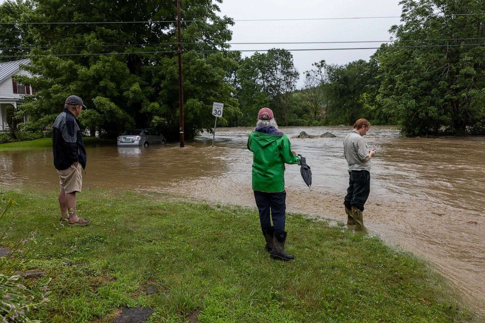 PHOTO: Onlookers check out a flooded road on July 10, 2023 in Chester, Vt. Torrential rain and flooding has affected millions of people from Vermont south to North Carolina.