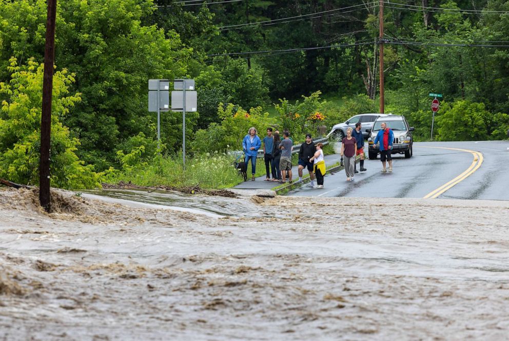 PHOTO: Onlookers check out a flooded road on July 10, 2023 in Chester, Vt.