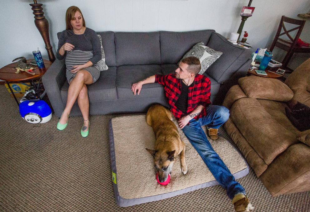 PHOTO: Joe Steenbeke and his wife Stephanie sit in their living room with Tess at their home in Culver, Ind. The northern Indiana veteran was reunited with the bomb-sniffing dog he served with years ago in Afghanistan.