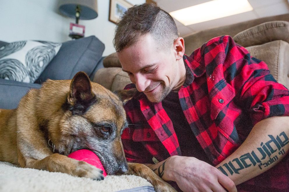 PHOTO: Joe Steenbeke plays with Tess at their home in Culver, Ind. The northern Indiana veteran was reunited with the bomb-sniffing dog he served with years ago in Afghanistan. 