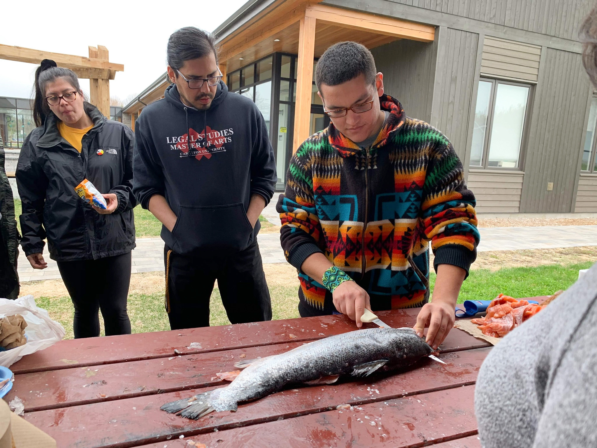 PHOTO: Victor Lopez-Carmen prepares fish to cook with other Indigenous young people.