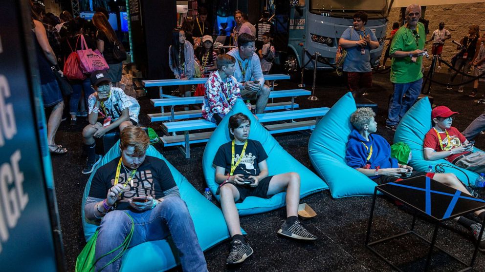 Photo: Attendees play video games at the Ax booth at VidCon in Anaheim, California, July 11, 2019. 