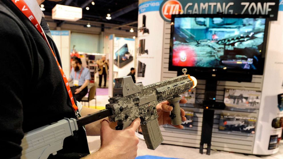 PHOTO: A player uses a U.S. Army Elite Force Assault Rifle Controller to play a video game at the CTA Digital booth at the 2012 International Consumer Electronics Show, January 12, 2012, in Las Vegas.