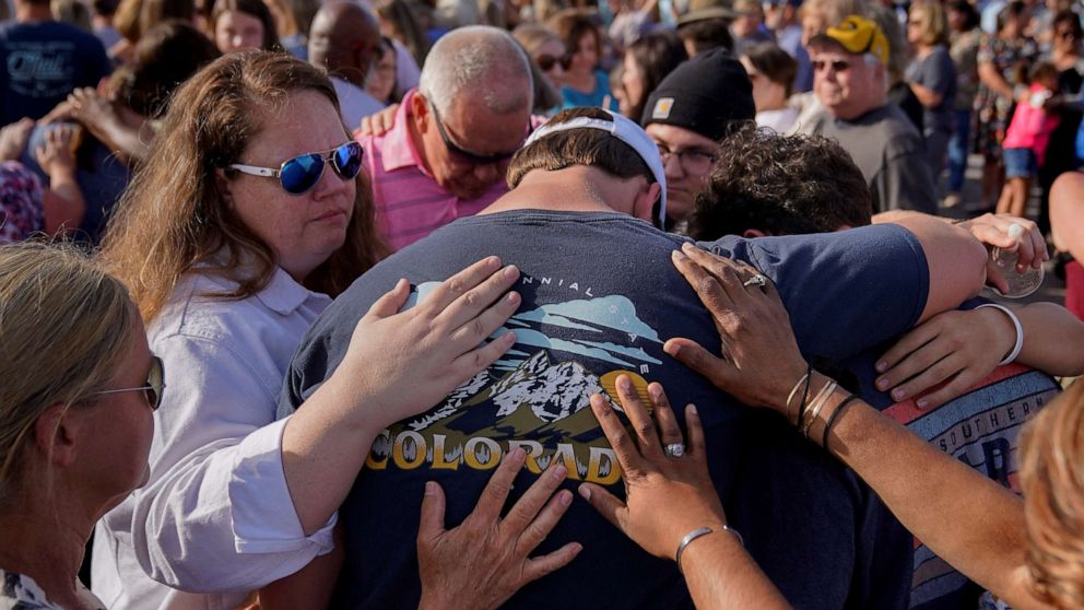 PHOTO: Community members embrace each other during a vigil the day after a shooting during a teenager's birthday party at Mahogany Masterpiece Dance Studio in Dadeville, Ala., April 16, 2023.