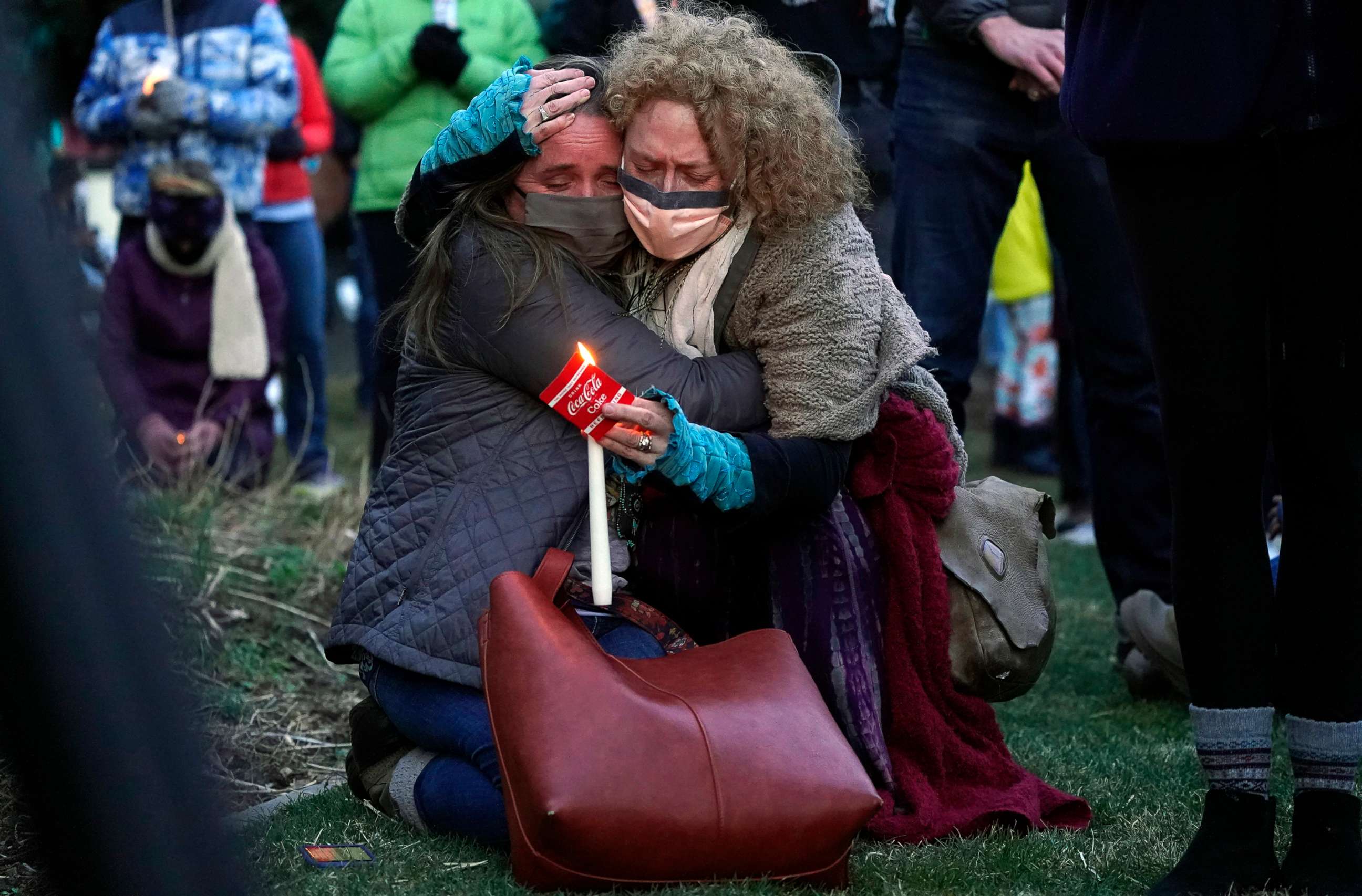 PHOTO: Mourners embrace at a vigil for the victims of a mass shooting at a grocery store earlier in the week, March 24, 2021, outside the courthouse in Boulder, Colo.