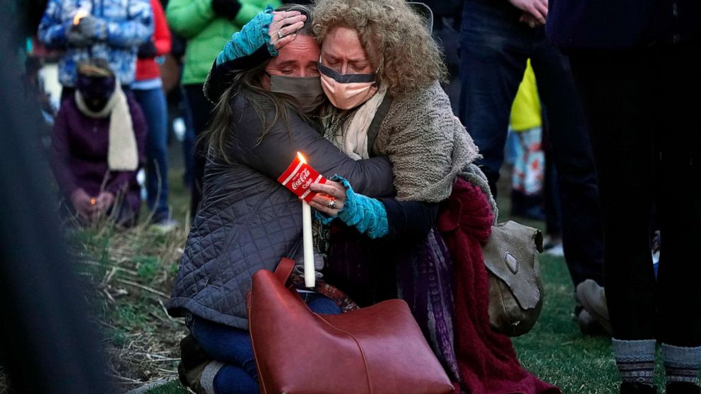 PHOTO: Mourners embrace at a vigil for the victims of a mass shooting at a grocery store earlier in the week, March 24, 2021, outside the courthouse in Boulder, Colo.