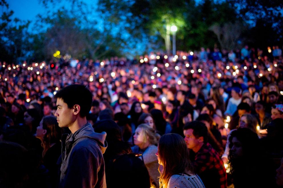 PHOTO: People gather at a park for a candlelight vigil to honor the victims of a shooting, May 24, 2014, in Isla Vista, Calif.