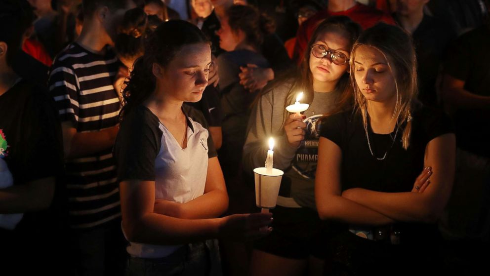 PHOTO: People attend a candle light memorial service for the victims of the shooting at Marjory Stoneman Douglas High School that killed 17 people, Feb. 15, 2018 in Parkland, Fla. 