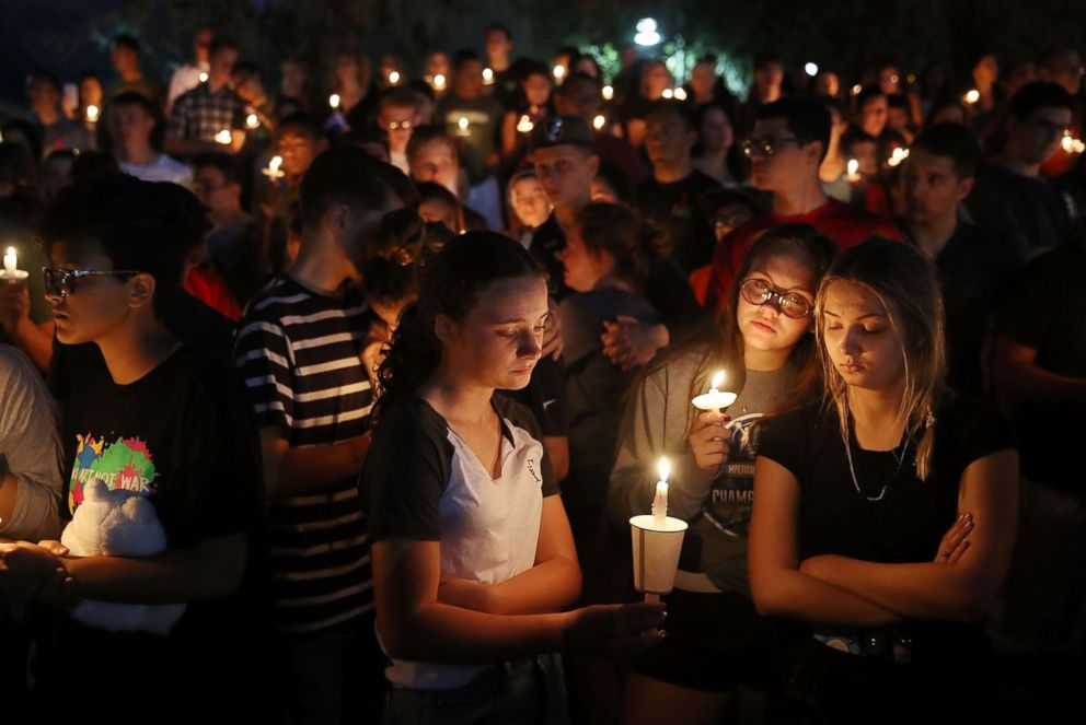 PHOTO: People attend a candle light memorial service for the victims of the shooting at Marjory Stoneman Douglas High School , Feb. 15, 2018 in Parkland, Fla.