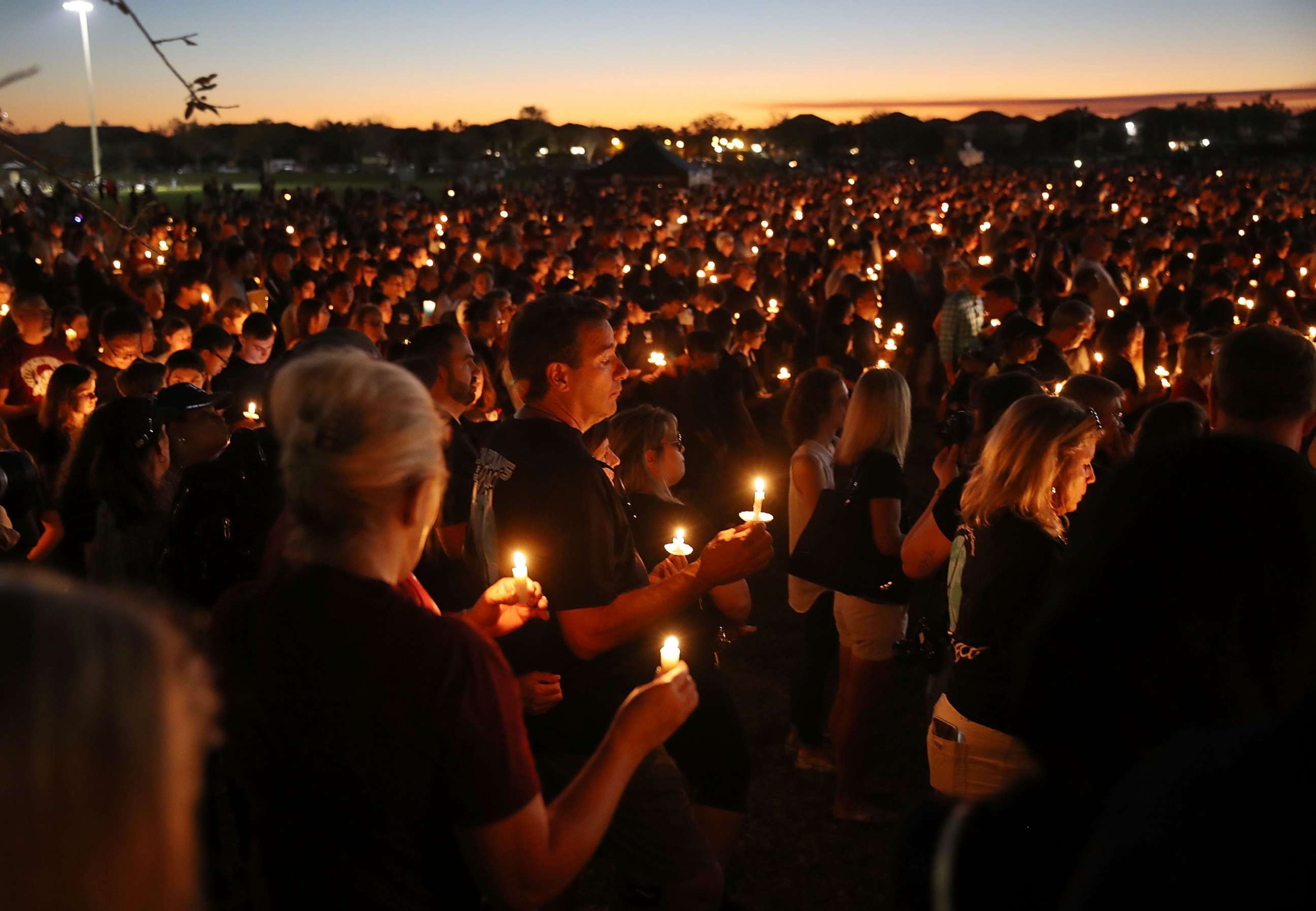 PHOTO: People attend a candle light memorial service for the victims of the shooting at Marjory Stoneman Douglas High School that killed 17 people,  Feb. 15, 2018, in Parkland, Fla. 