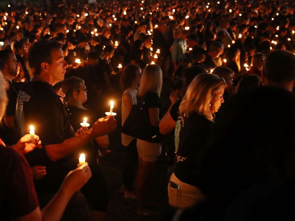 PHOTO: People attend a candle light memorial service for the victims of the shooting at Marjory Stoneman Douglas High School that killed 17 people, Feb. 15, 2018, in Parkland, Fla. 