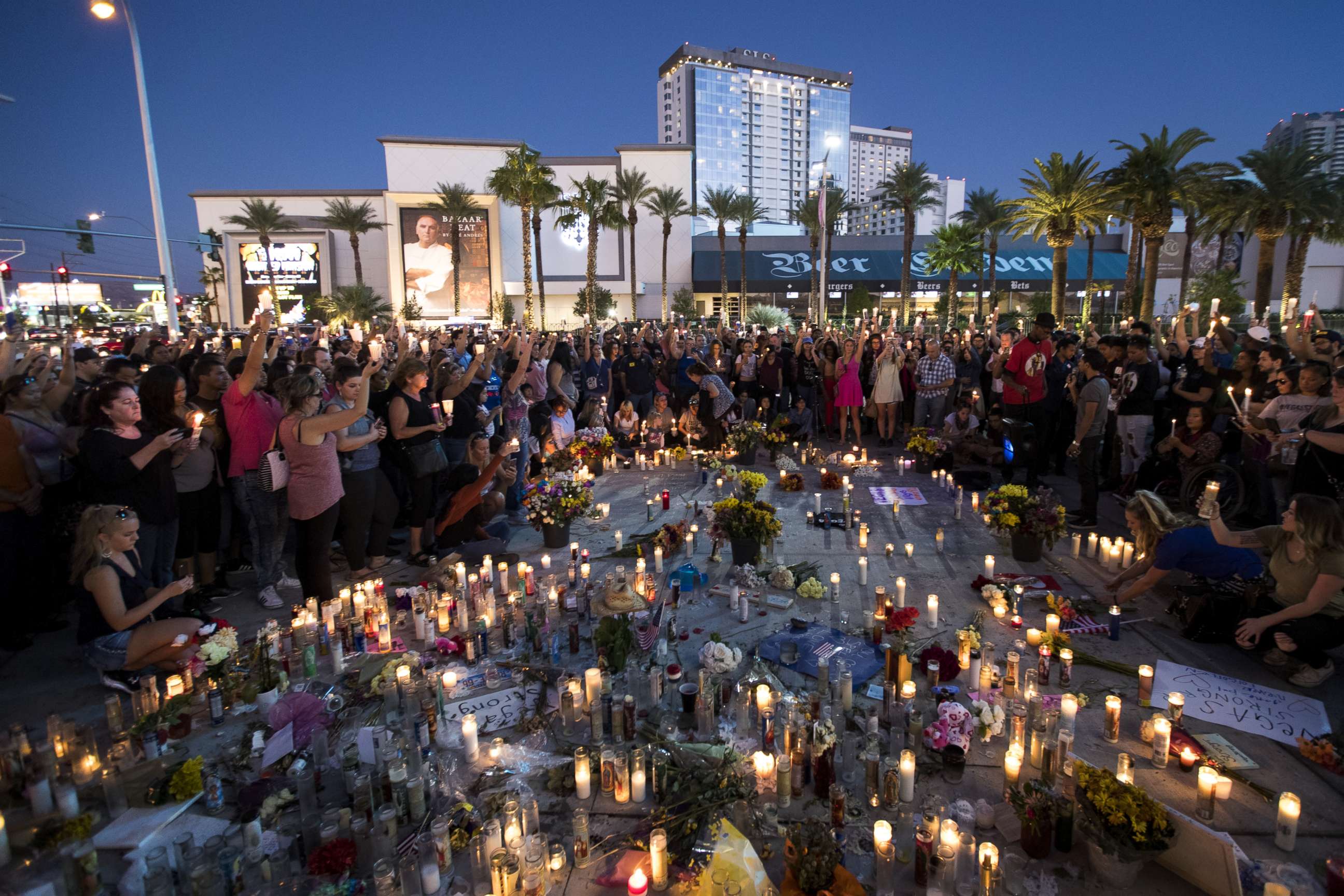 PHOTO: Mourners hold their candles in the air during a moment of silence during a vigil to mark one week since the mass shooting at the Route 91 Harvest country music festival, Oct. 8, 2017 in Las Vegas. 