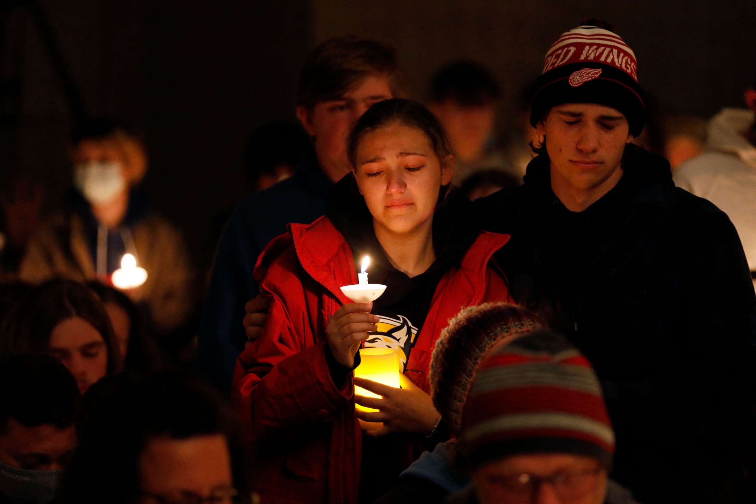 PHOTO: Oxford High students hold during a vigil after a shooting at Oxford High School at Lake Pointe Community Church in Lake Orion, Mich., Nov. 30, 2021.