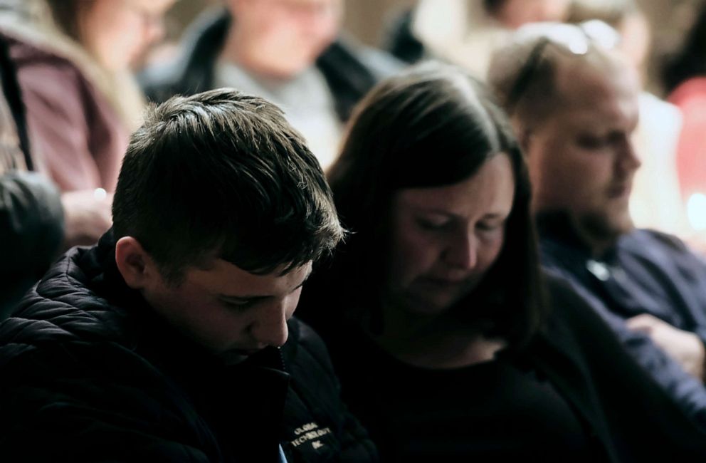 PHOTO: A young man reportedly wounded during the shooting at Oxford High School joins other community members during a vigil at the Lake Point Community Church, Nov. 30, 2021, in Oxford, Mich.