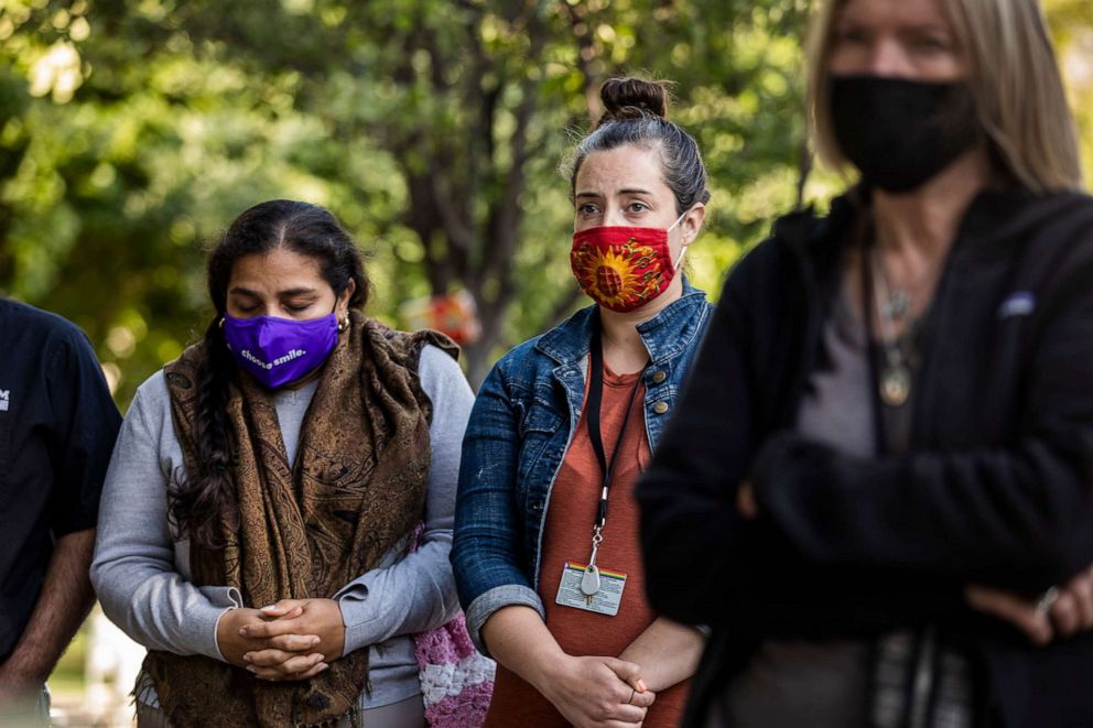 PHOTO: People take part in a vigil held by the Interfaith Community following the mass shooting at the Valley Transportation Authority (VTA) light-rail yard, at St. James Park, May 26, 2021, in San Jose, Calif.