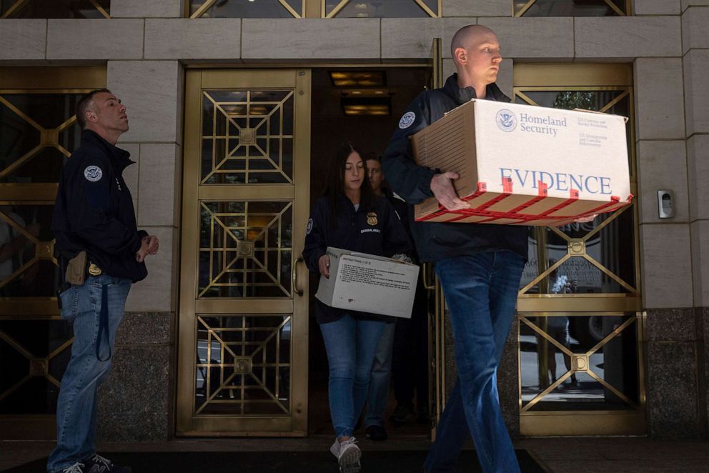 PHOTO: Federal agents carry evidence boxes as they walk out of a Park Avenue high-rise on Sep. 1, 2022, in New York.