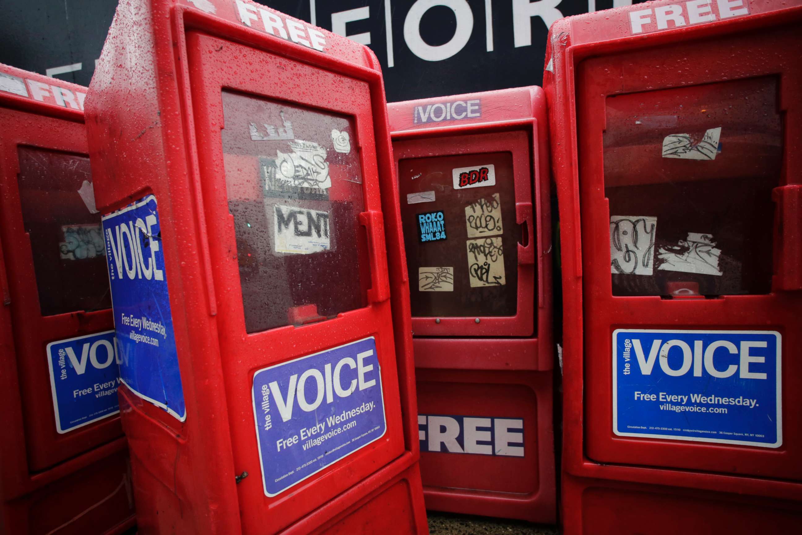 PHOTO: Plastic newspaper boxes for The Village Voice stand along a Manhattan sidewalk in New York on Nov. 27, 2013. Village Voice publisher Peter Barbey announced on Aug. 31, 2018, that the venerable alternative weekly will cease publication. 