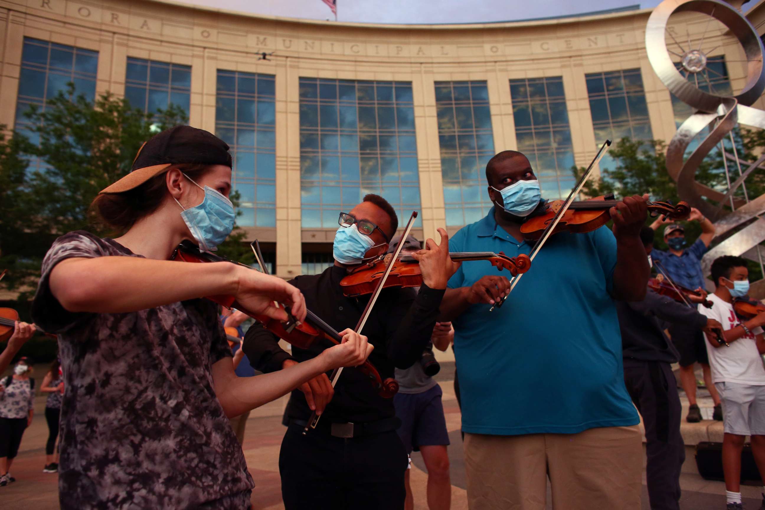 PHOTO: Protesters play along with other violinists to honor Elijah McClain, who, when alive, would play his violin at animal shelters because he thought the kittens were lonely, during a vigil in Aurora, Colorado, June 27, 2020.