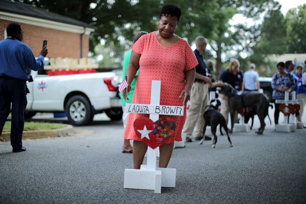 PHOTO: Patricia Olds, co-worker of shooting victim Laquita Brown, prepares to place a cross with Brown's name at a makeshift memorial at the Municipal Center June 2, 2019 in Virginia Beach, Va. 