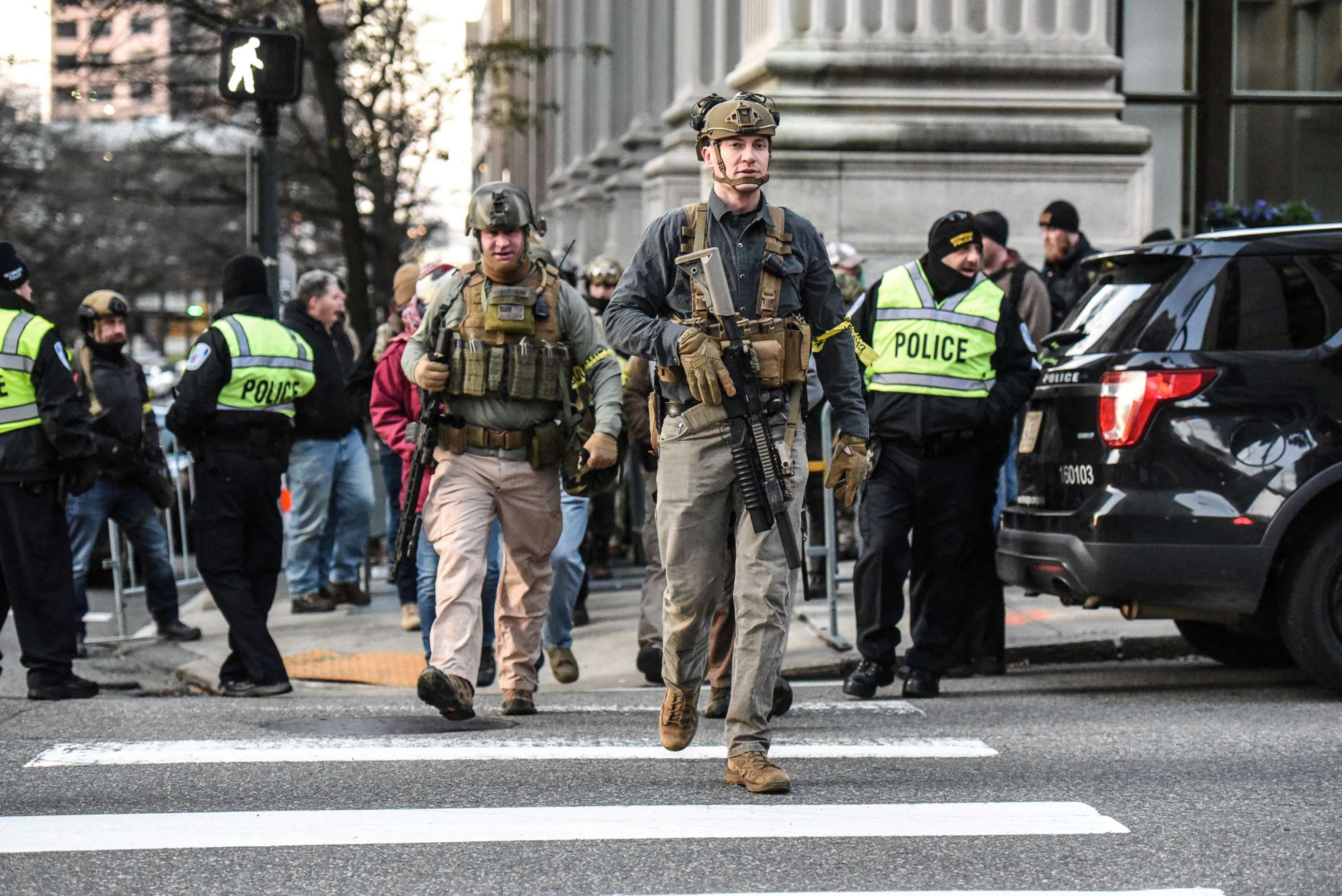 PHOTO: People who are part of an armed militia group walk near the Virginia State Capitol building to advocate for gun rights in Richmond, Va., Jan. 20, 2020. 
