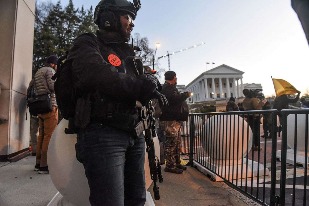 PHOTO: A person carrying a gun stands near the Virginia State Capitol building to advocate for gun rights in Richmond, Va. Jan. 20, 2020. 