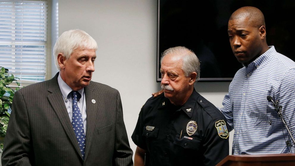 PHOTO: Virginia Beach Mayor Bobby Dyer, left, looks on as City Councilman Aaron Rouse, right, comforts Chief of Police James Cervera following a press conference, May 31, 2019 in Virginia Beach, Va.