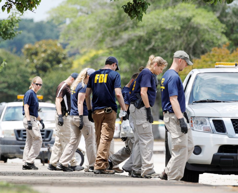 PHOTO: FBI Evidence Response Team members search a parking lot outside a municipal government building where a shooting incident occurred in Virginia Beach, Va., June 1, 2019.