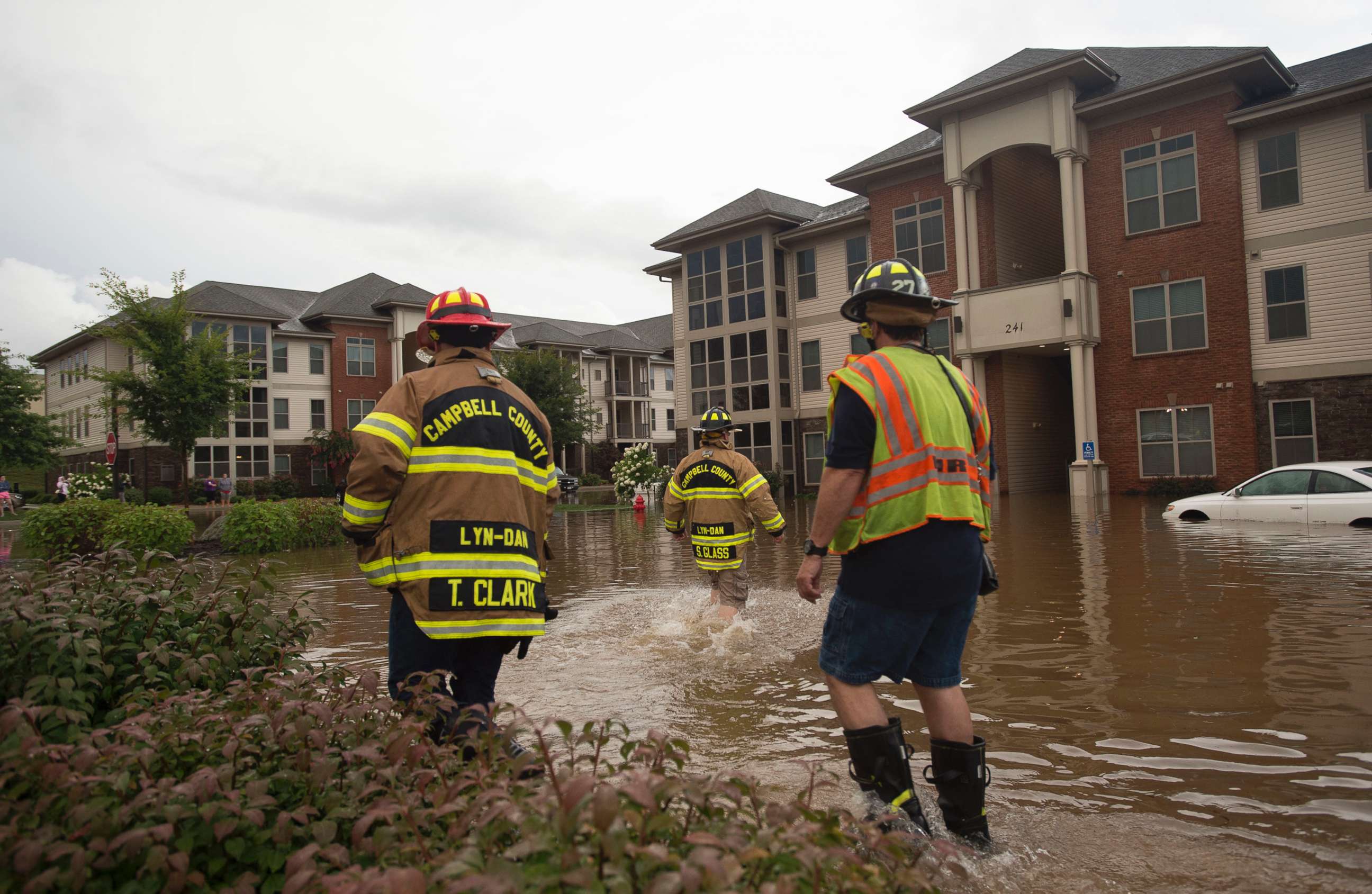 PHOTO: Members of the Campbell County Fire Department wade through water at an apartment complex in Lynchburg, Va., Aug. 2, 2018.