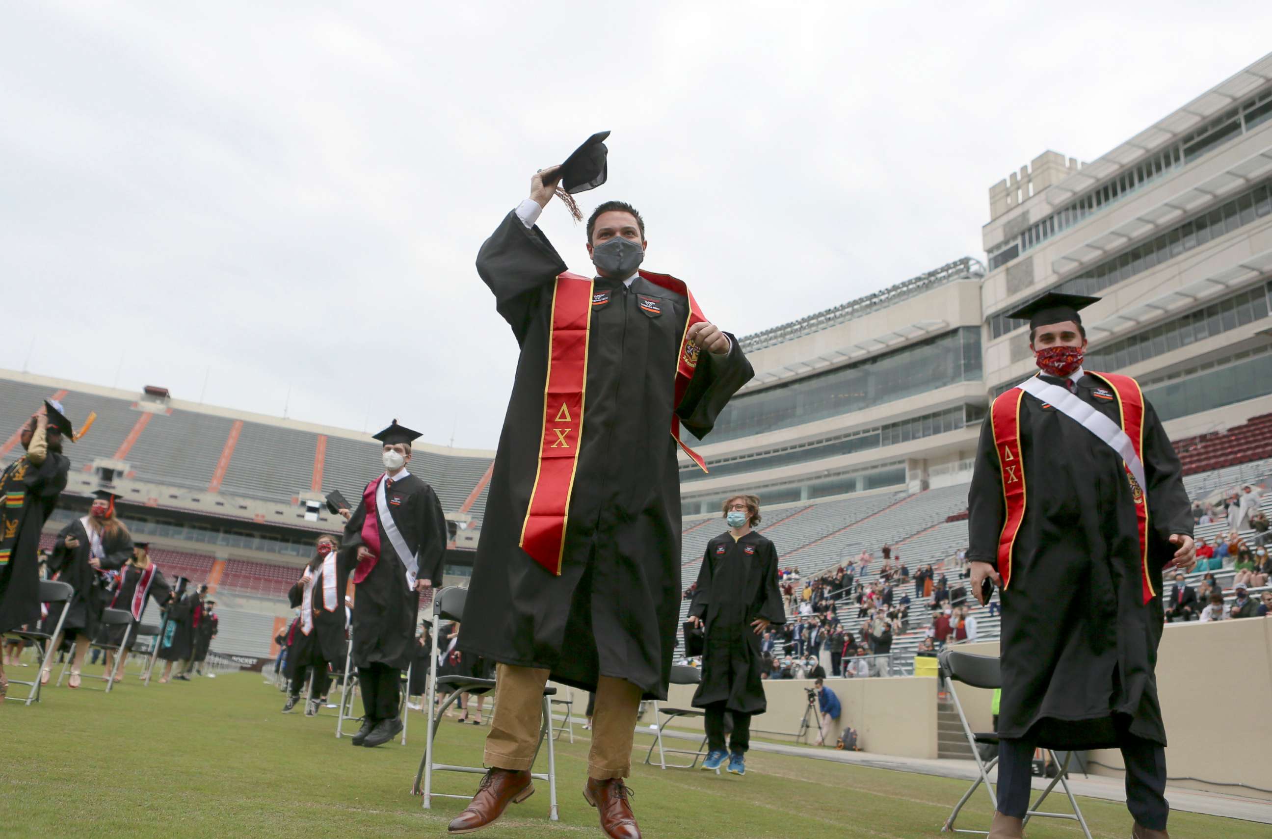 PHOTO: Austin Abraham, center, celebrates with his class of 2020 classmates at the conclusion of graduation in Blacksburg, Va., May 12 2021.