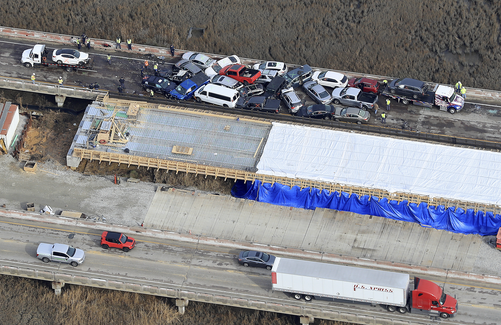 PHOTO: Crews work to clear vehicles from the Queens Creek overpass on I-64 in York County, Va., Dec. 22, 2019 after a chain-reaction crash involving multiple vehicles cars.