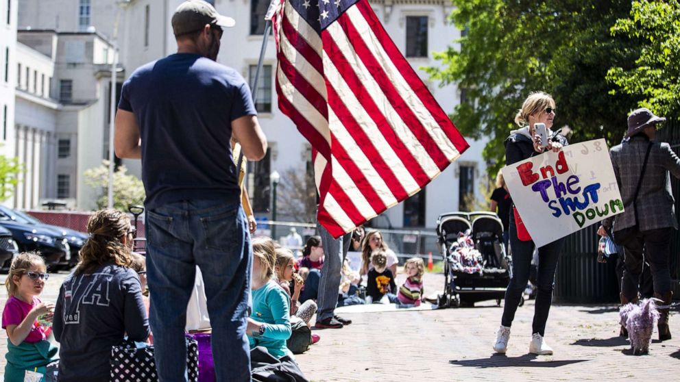 PHOTO: Demonstrators stand outside of the Virginia State Capitol, April 16, 2020, in Richmond, Va., to protest continuing Virginia Gov. Ralph Northam's stay at home order during the coronavirus pandemic.