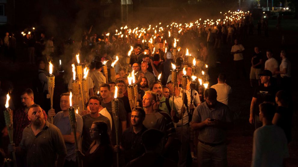 White nationalists carry torches on the grounds of the University of Virginia, on the eve of a planned Unite The Right rally in Charlottesville, Va., Aug. 11, 2017.