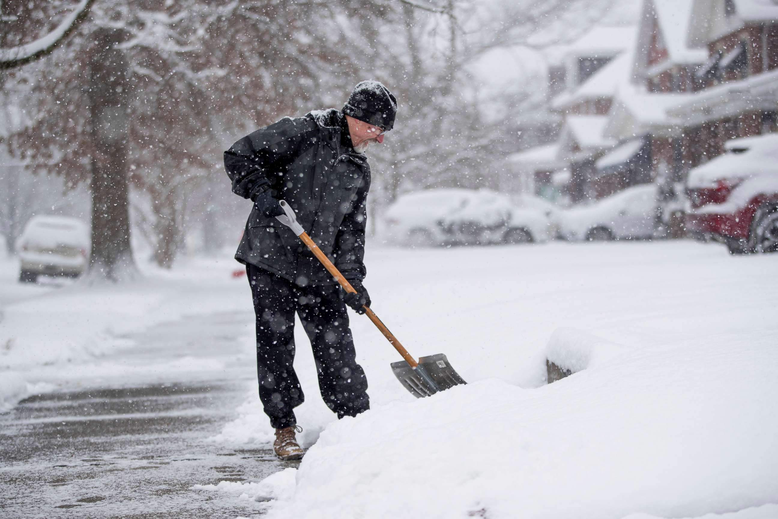 PHOTO: Edward Tucker shovels snow from his neighbor's sidewalk on Friday, Dec. 25, 2020, in Huntington, W.Va. 